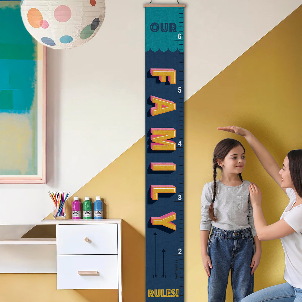 Child and adult measuring height against a 'Our Family Rules' growth chart in a room with a colorful wall and desk.